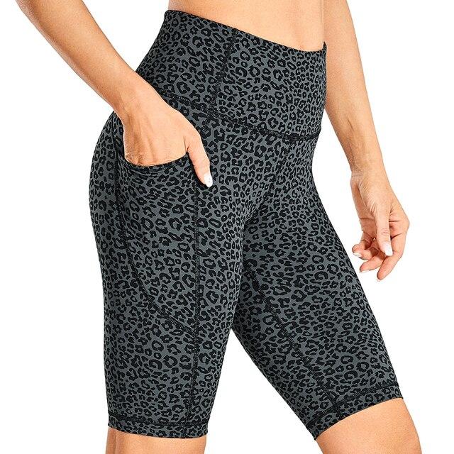Women's Naked Feeling Workout Shorts in black, featuring a high waist and 10-inch inseam, designed for yoga and athletic activities with pockets.