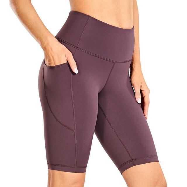 Women's Naked Feeling Workout Shorts in black, featuring a high waist and 10-inch inseam, designed for yoga and athletic activities with pockets.