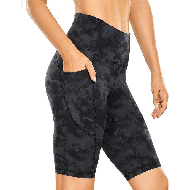 Women's Naked Feeling Workout Shorts in black, featuring a high waist and 10-inch inseam, designed for yoga and athletic activities with pockets.