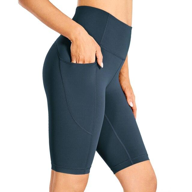 Women's Naked Feeling Workout Shorts in black, featuring a high waist and 10-inch inseam, designed for yoga and athletic activities with pockets.
