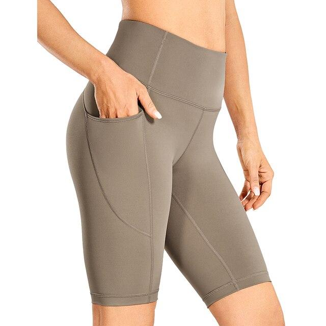 Women's Naked Feeling Workout Shorts in black, featuring a high waist and 10-inch inseam, designed for yoga and athletic activities with pockets.