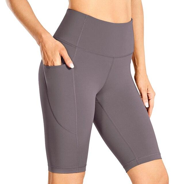 Women's Naked Feeling Workout Shorts in black, featuring a high waist and 10-inch inseam, designed for yoga and athletic activities with pockets.