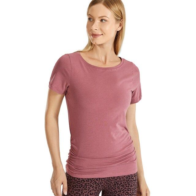 A stylish Women's Pima Cotton Short Sleeve Workout Shirt in a slim-fit design, featuring side shirring, perfect for yoga and workouts.