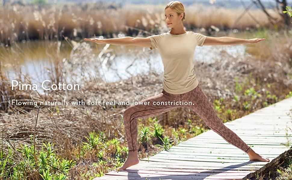 A stylish Women's Pima Cotton Short Sleeve Workout Shirt in a slim-fit design, featuring side shirring, perfect for yoga and workouts.