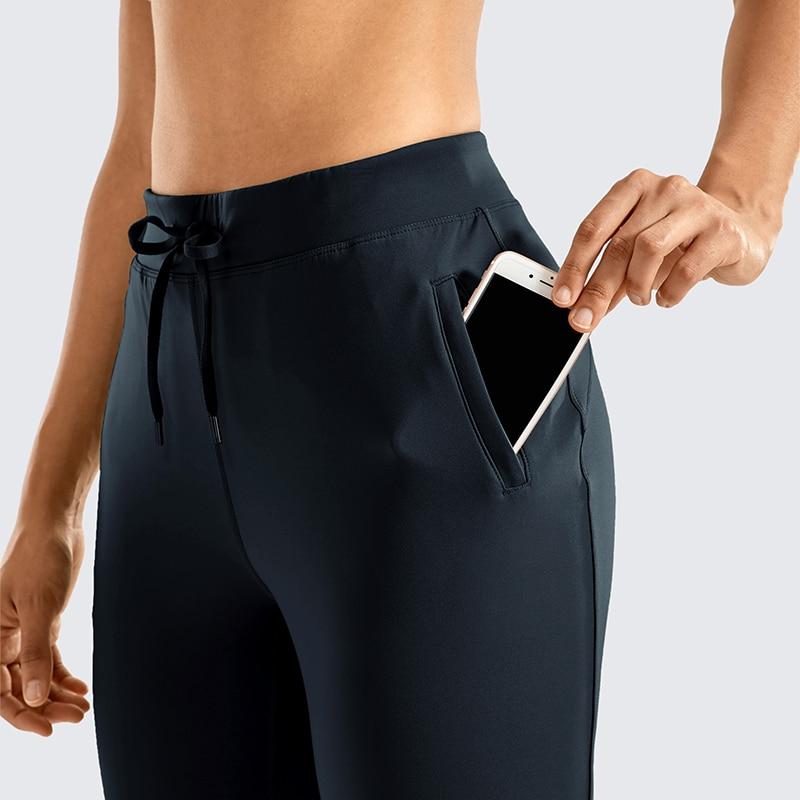 A pair of women's stretch casual jogger pants in black with a drawstring waist and zipper pockets, perfect for travel and lounging.