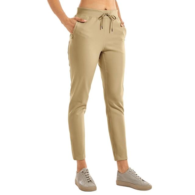 A pair of women's stretch casual jogger pants in black with a drawstring waist and zipper pockets, perfect for travel and lounging.