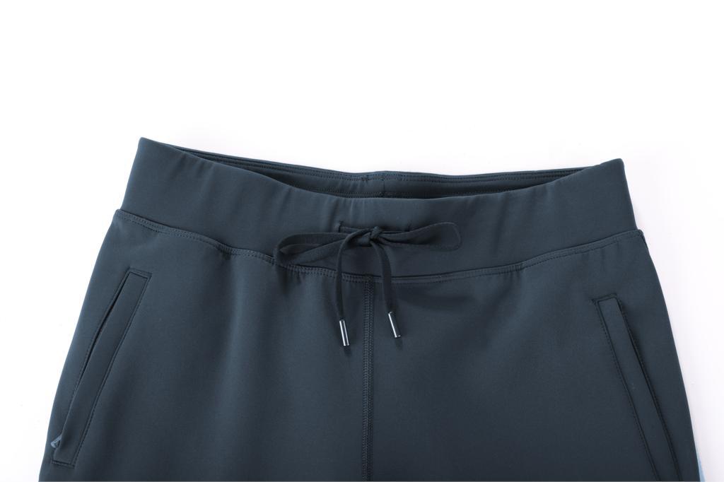 A pair of women's stretch casual jogger pants in black with a drawstring waist and zipper pockets, perfect for travel and lounging.