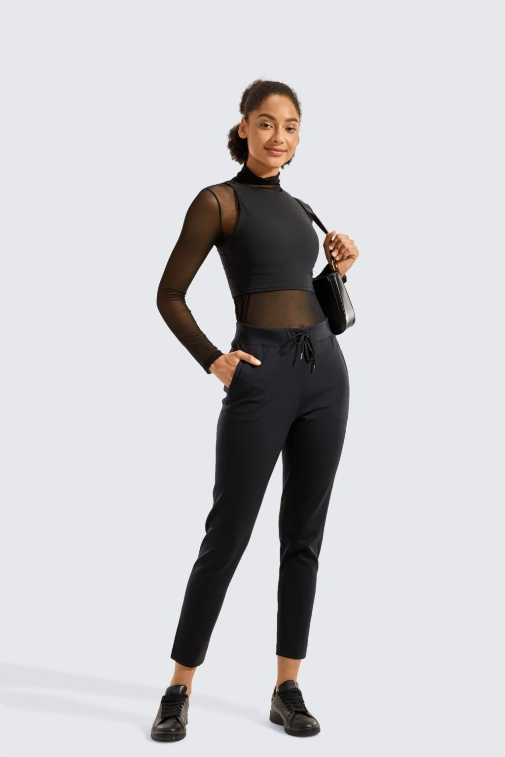 A pair of women's stretch casual jogger pants in black with a drawstring waist and zipper pockets, perfect for travel and lounging.