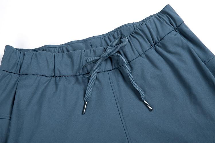 A pair of women's stretch lounge sweatpants in a stylish design, featuring a drawstring closure and pockets, perfect for travel and athletic training.