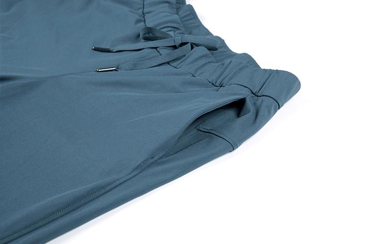 A pair of women's stretch lounge sweatpants in a stylish design, featuring a drawstring closure and pockets, perfect for travel and athletic training.