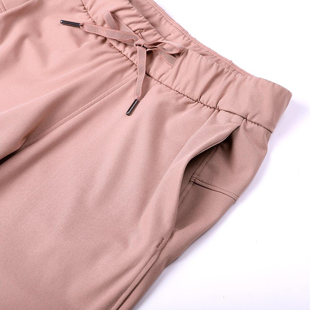 A pair of women's stretch lounge sweatpants in a stylish design, featuring a drawstring closure and pockets, perfect for travel and athletic training.