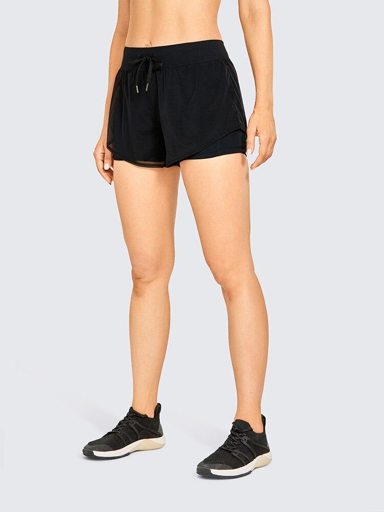 A pair of women's 2 in 1 workout running shorts featuring a quick-dry liner, elastic waistband, and a small pocket, designed for comfort and performance.