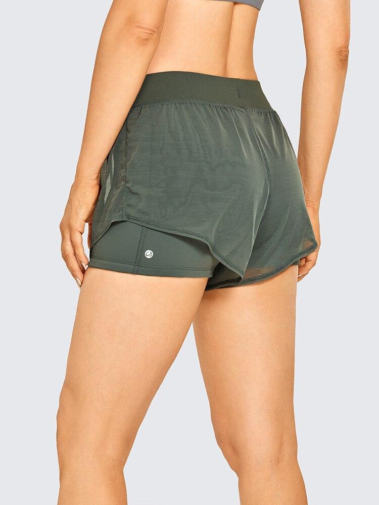 A pair of women's 2 in 1 workout running shorts featuring a quick-dry liner, elastic waistband, and a small pocket, designed for comfort and performance.