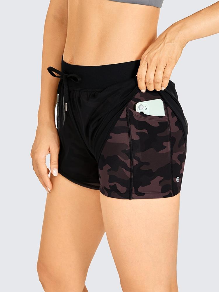 A pair of women's 2 in 1 workout running shorts featuring a quick-dry liner, elastic waistband, and a small pocket, designed for comfort and performance.