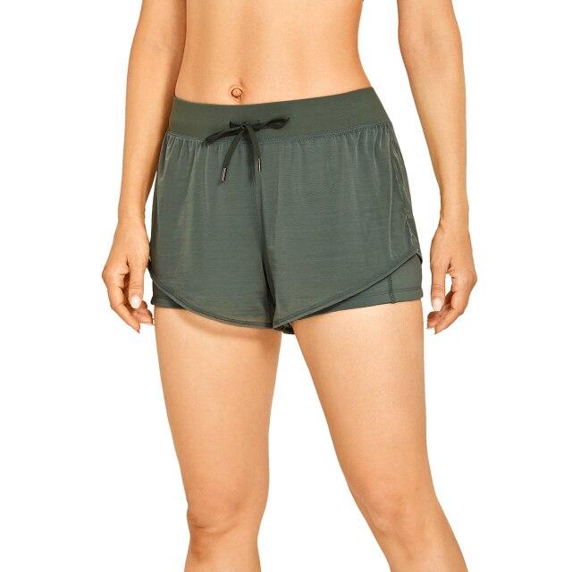 A pair of women's 2 in 1 workout running shorts featuring a quick-dry liner, elastic waistband, and a small pocket, designed for comfort and performance.