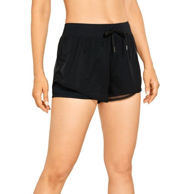 A pair of women's 2 in 1 workout running shorts featuring a quick-dry liner, elastic waistband, and a small pocket, designed for comfort and performance.