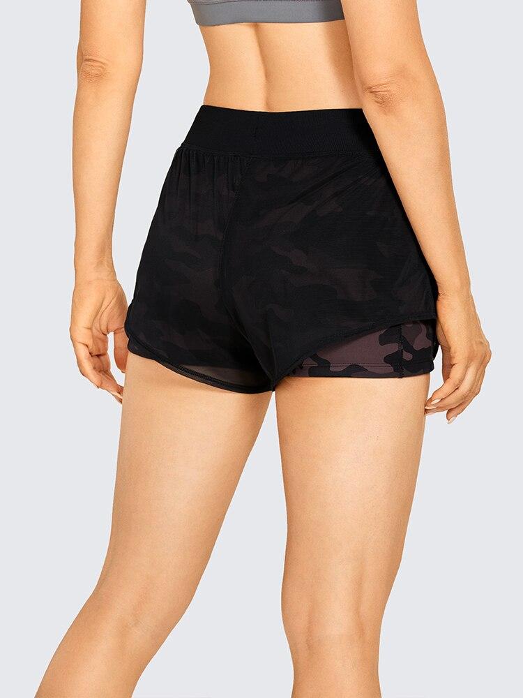 A pair of women's 2 in 1 workout running shorts featuring a quick-dry liner, elastic waistband, and a small pocket, designed for comfort and performance.