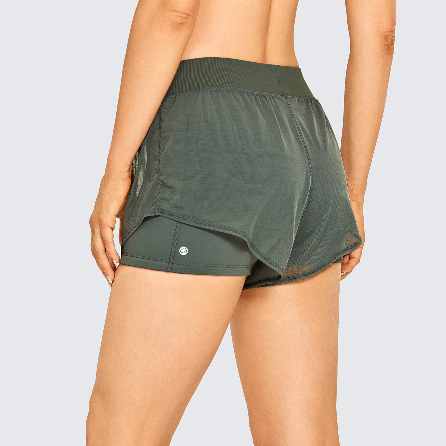 A pair of women's 2 in 1 workout running shorts featuring a quick-dry liner, elastic waistband, and a small pocket, designed for comfort and performance.