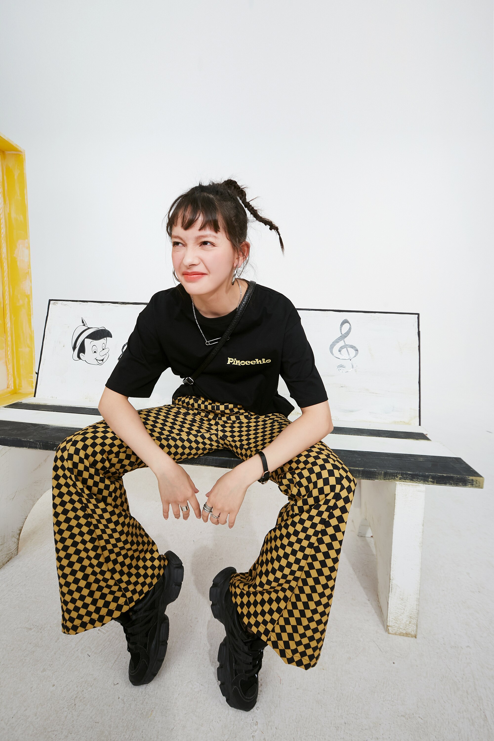 A pair of stylish yellow plaid high waist casual women flare pants, showcasing a chic design suitable for spring and autumn wear.