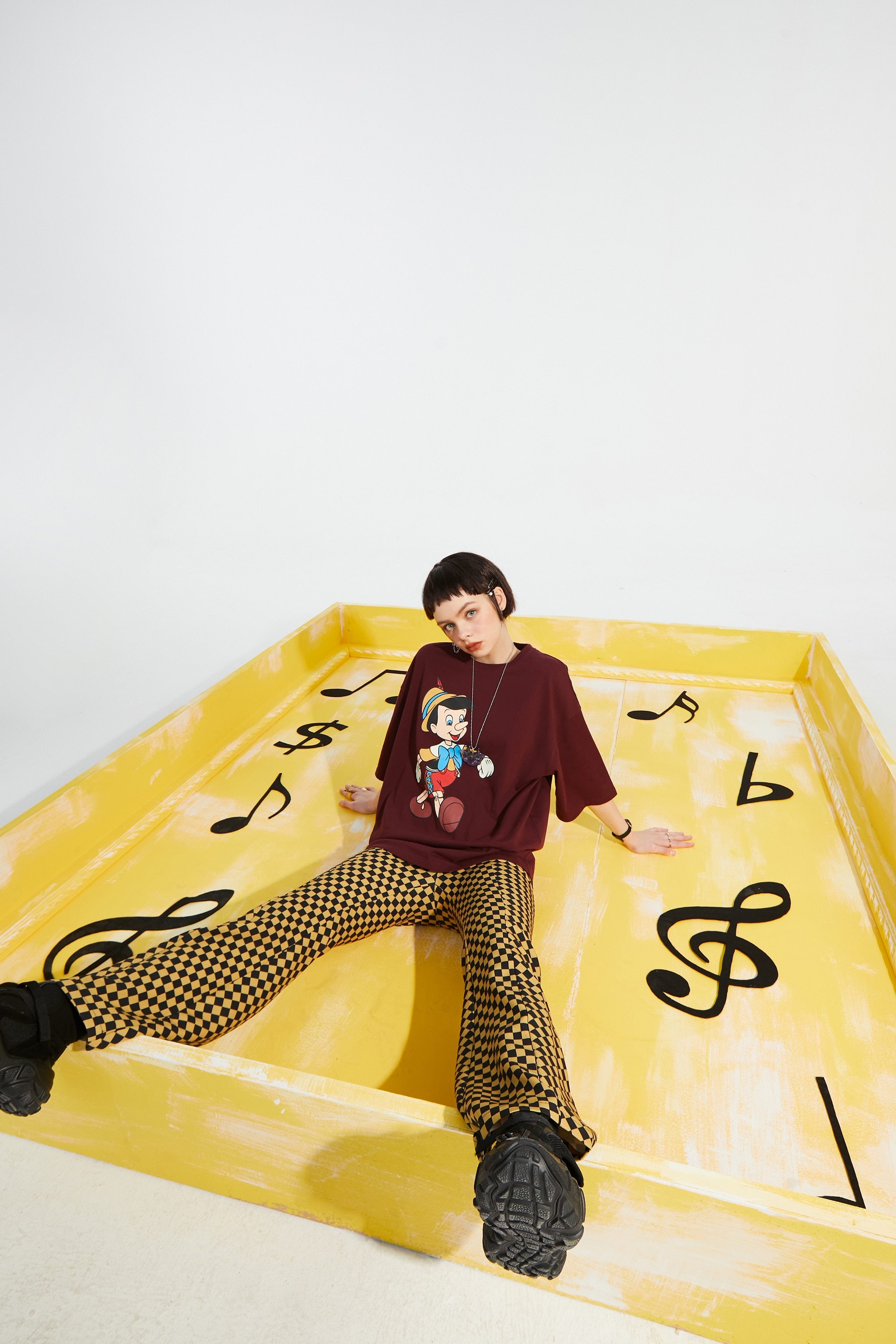 A pair of stylish yellow plaid high waist casual women flare pants, showcasing a chic design suitable for spring and autumn wear.