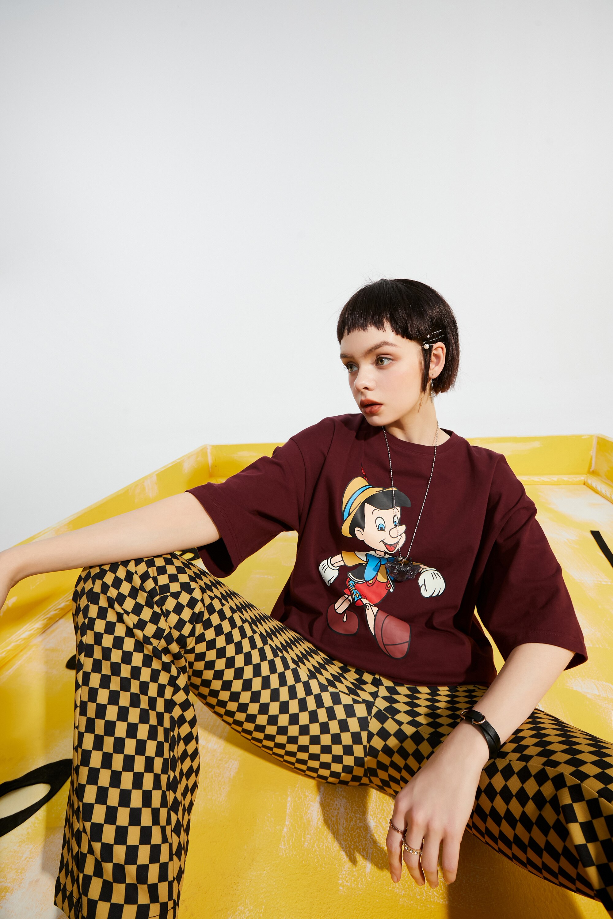 A pair of stylish yellow plaid high waist casual women flare pants, showcasing a chic design suitable for spring and autumn wear.