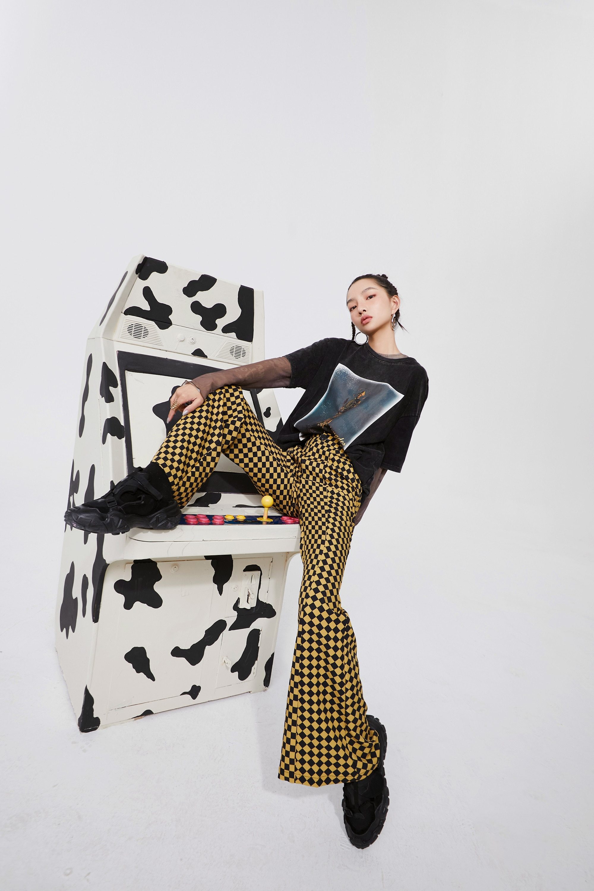 A pair of stylish yellow plaid high waist casual women flare pants, showcasing a chic design suitable for spring and autumn wear.