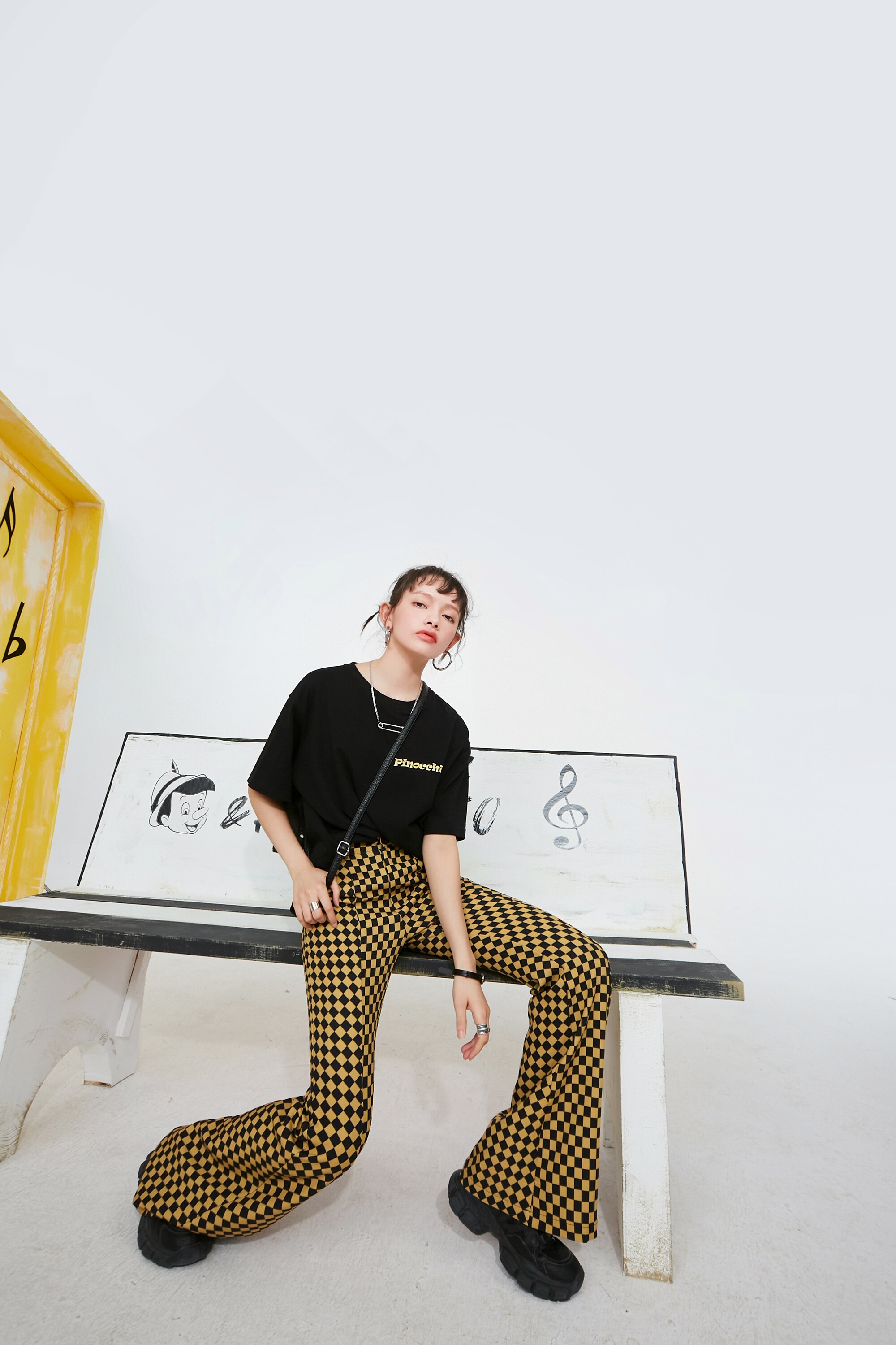 A pair of stylish yellow plaid high waist casual women flare pants, showcasing a chic design suitable for spring and autumn wear.