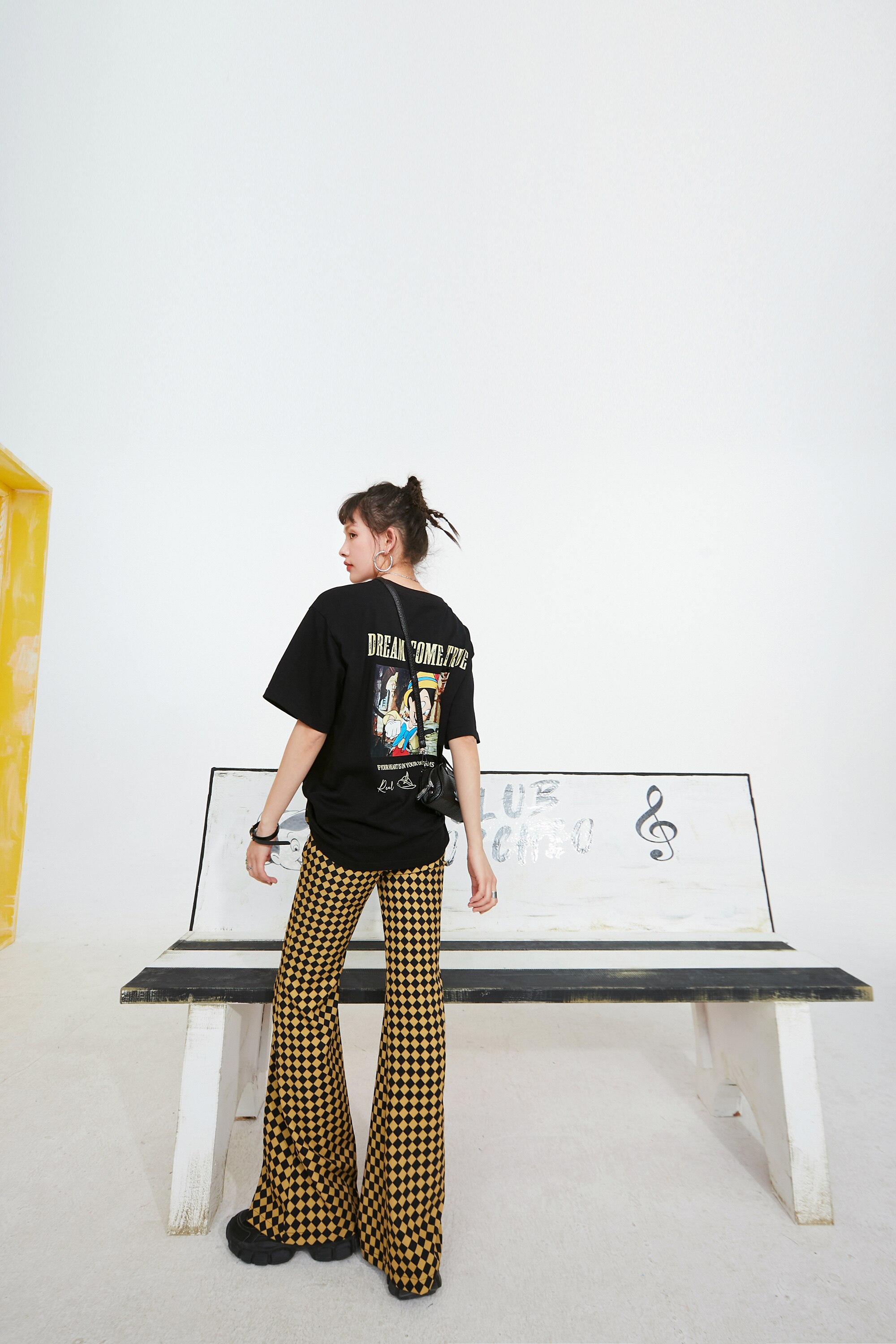 A pair of stylish yellow plaid high waist casual women flare pants, showcasing a chic design suitable for spring and autumn wear.