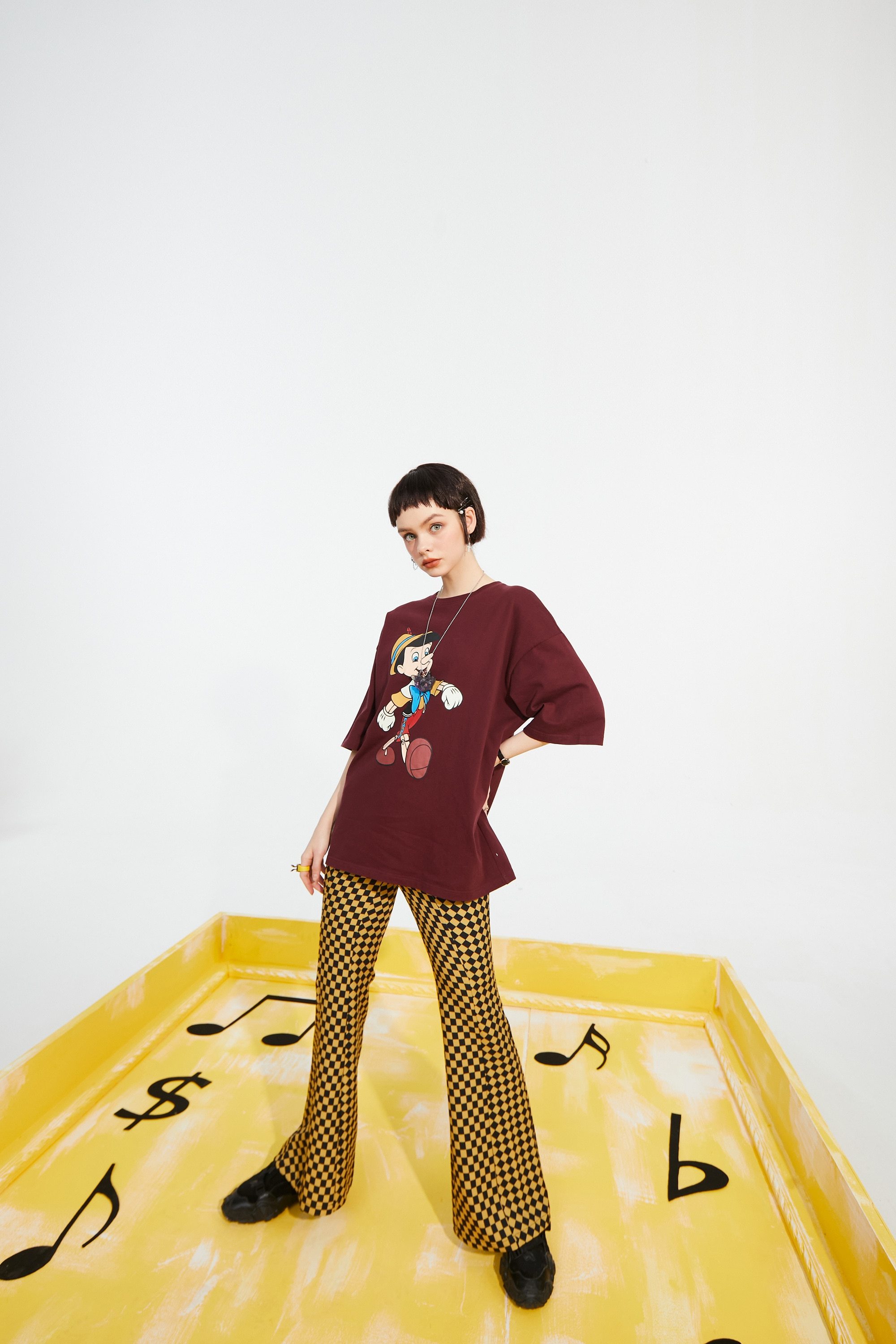 A pair of stylish yellow plaid high waist casual women flare pants, showcasing a chic design suitable for spring and autumn wear.