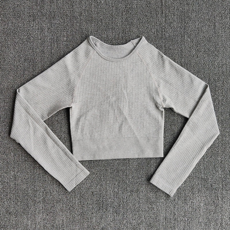 Women's seamless long sleeve yoga crop top in various colors, designed for fitness and comfort during workouts.