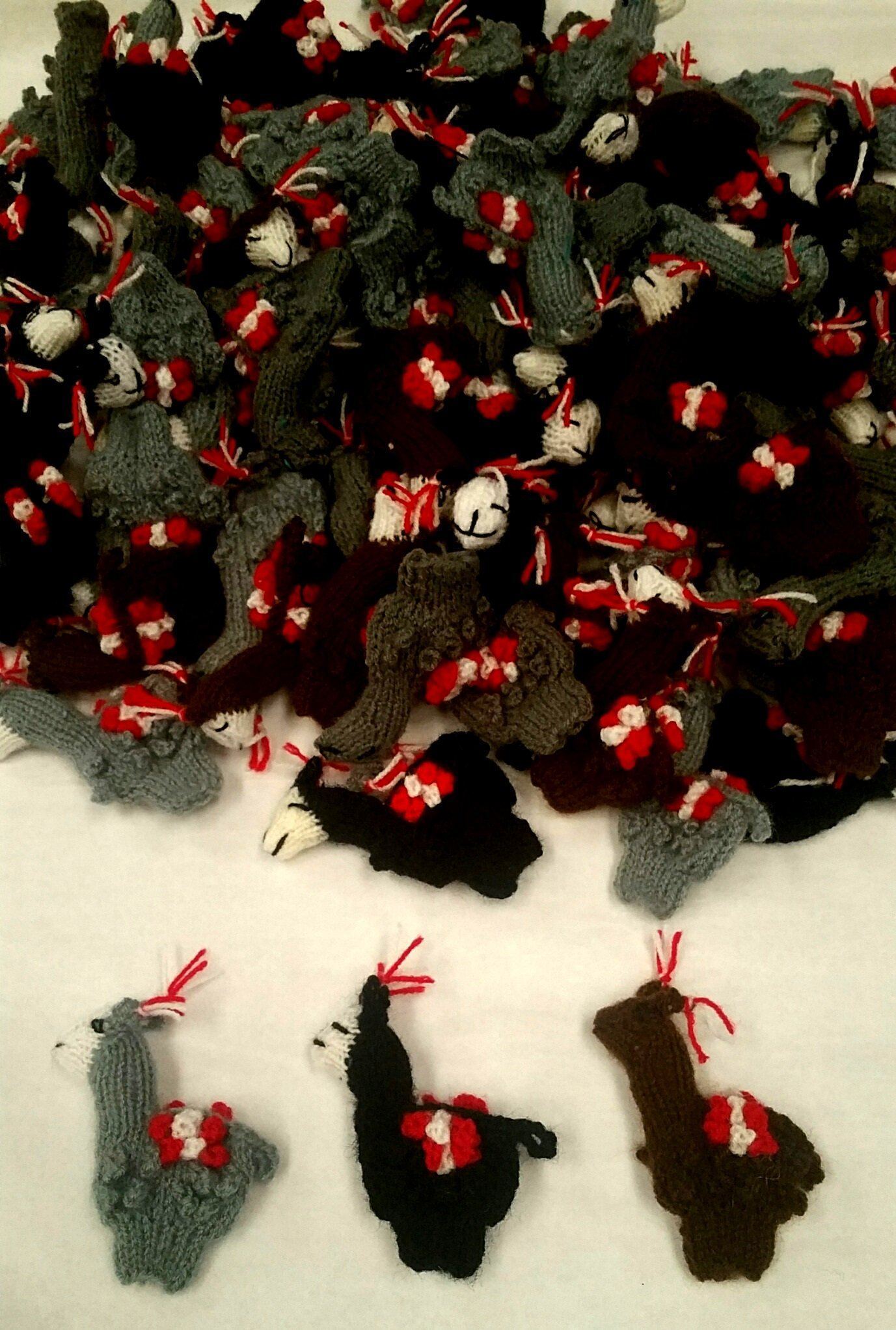 A colorful assortment of handmade alpaca finger puppets, featuring various colors and designs, perfect for children's play and gifts.