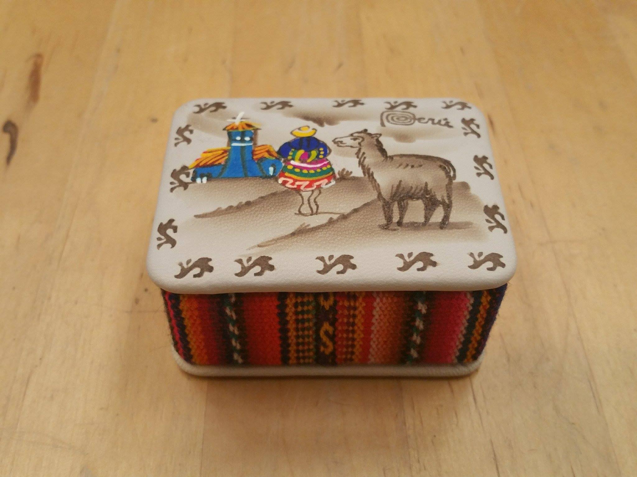 A beautifully crafted trinket box featuring a charming alpaca scene, handmade by Peruvian artisans, showcasing intricate details and vibrant colors.