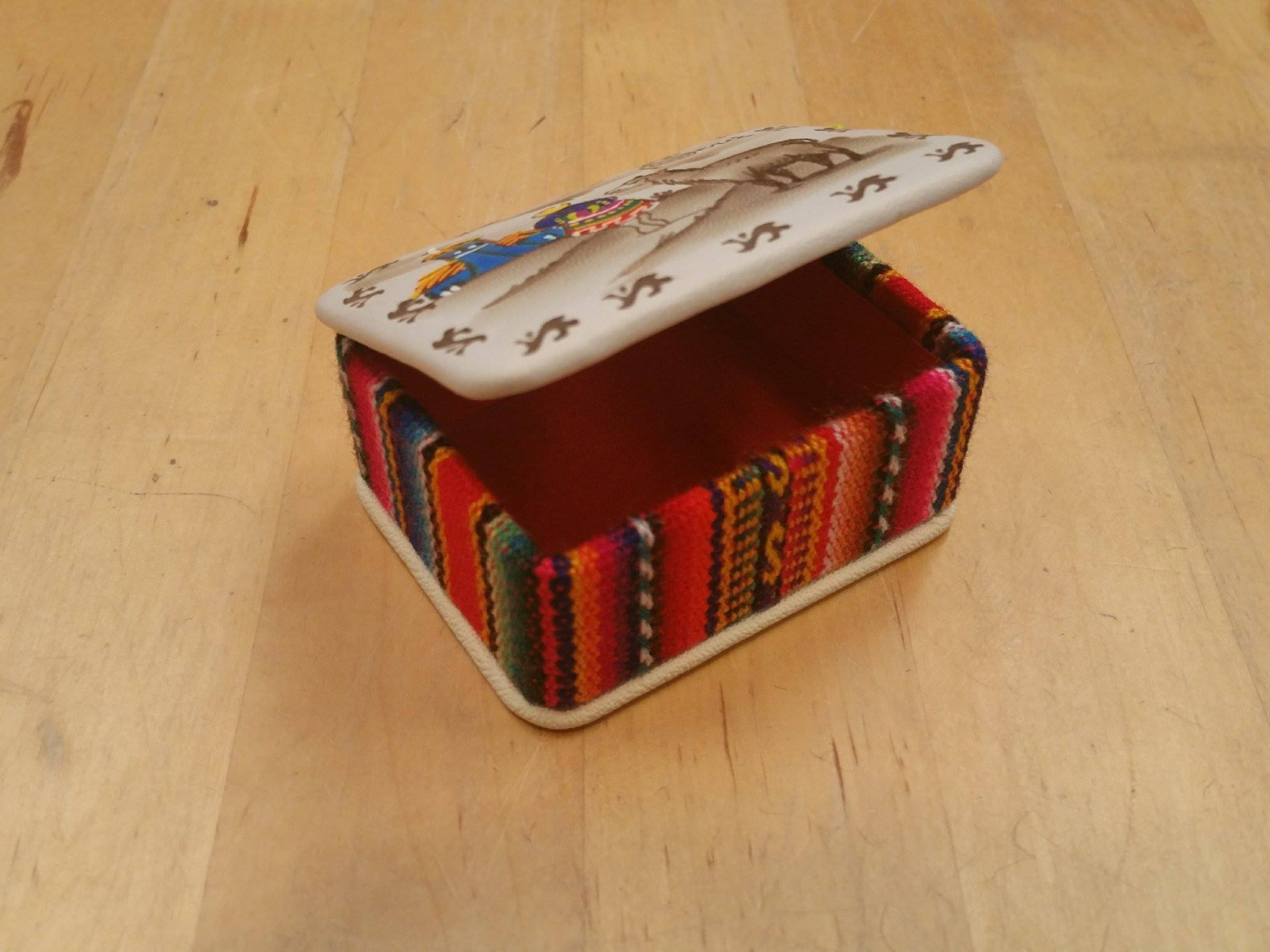 A beautifully crafted trinket box featuring a charming alpaca scene, handmade by Peruvian artisans, showcasing intricate details and vibrant colors.