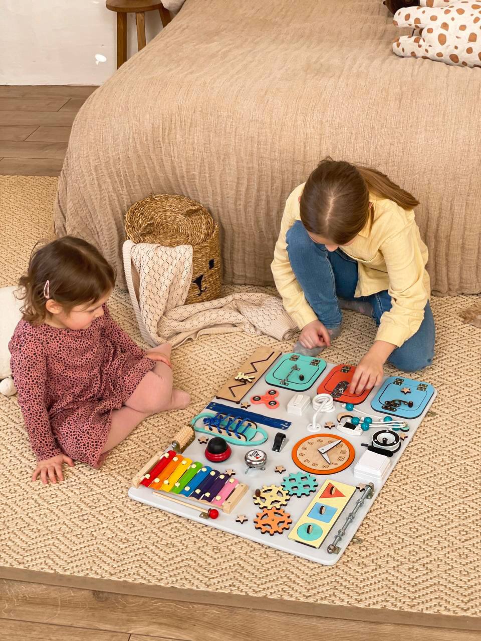 Multicolored Busy Board MAXI for toddlers featuring various engaging activities to enhance motor skills and creativity.