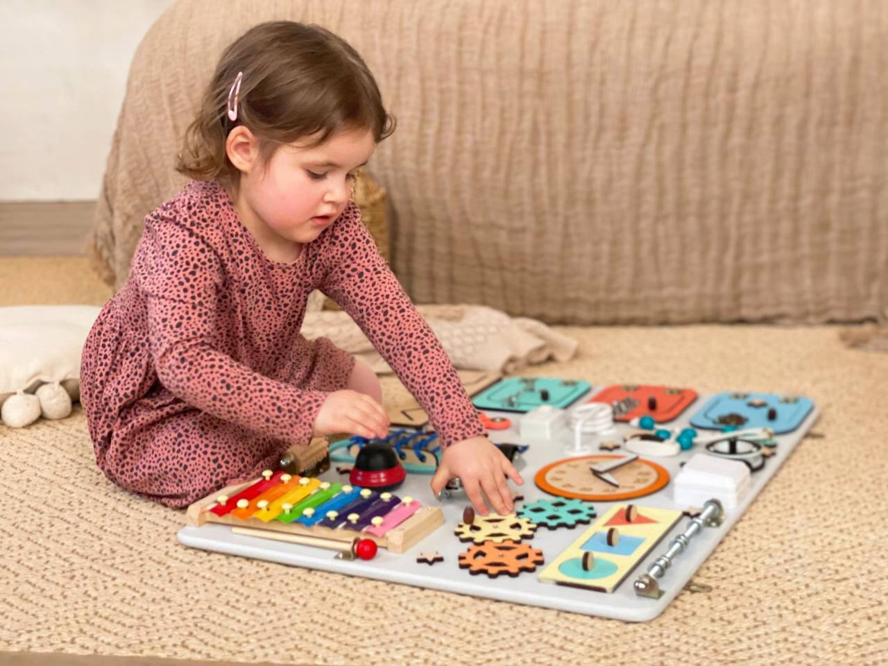 Multicolored Busy Board MAXI for toddlers featuring various engaging activities to enhance motor skills and creativity.