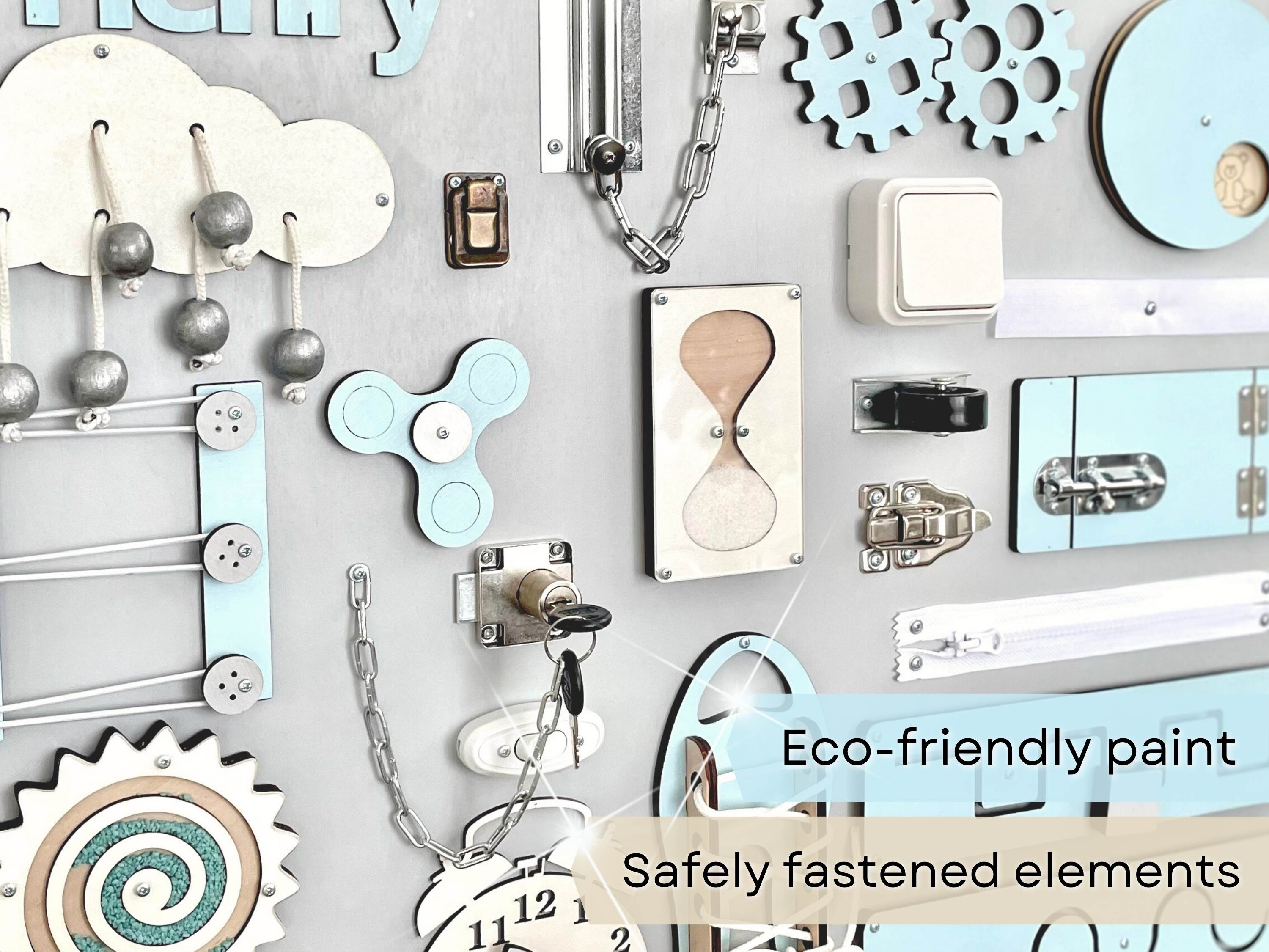 Busy Board MAXI in pastel blue, featuring various interactive elements for children's development.