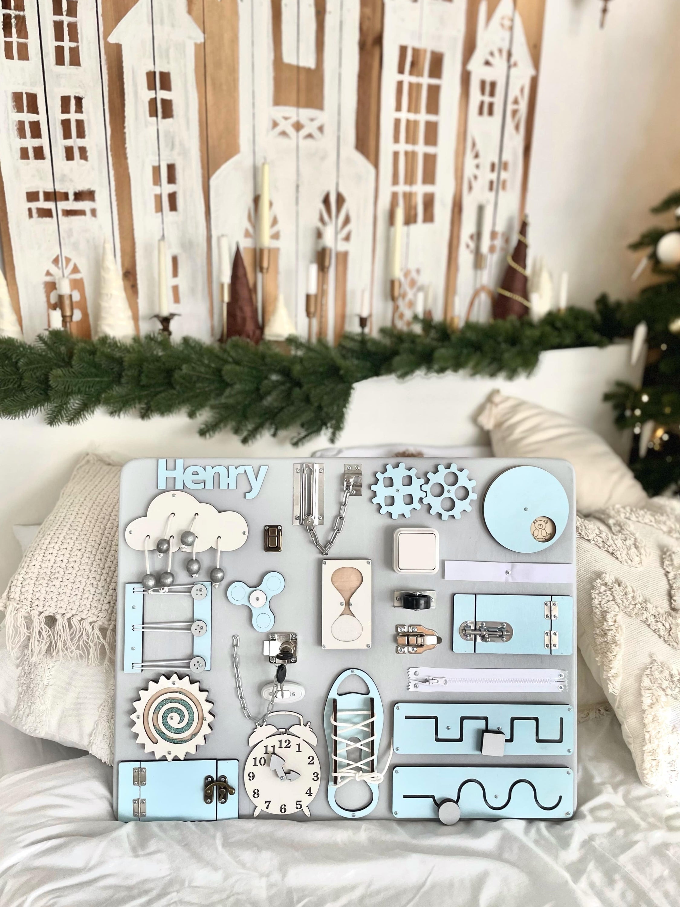 Busy Board MAXI in pastel blue, featuring various interactive elements for children's development.