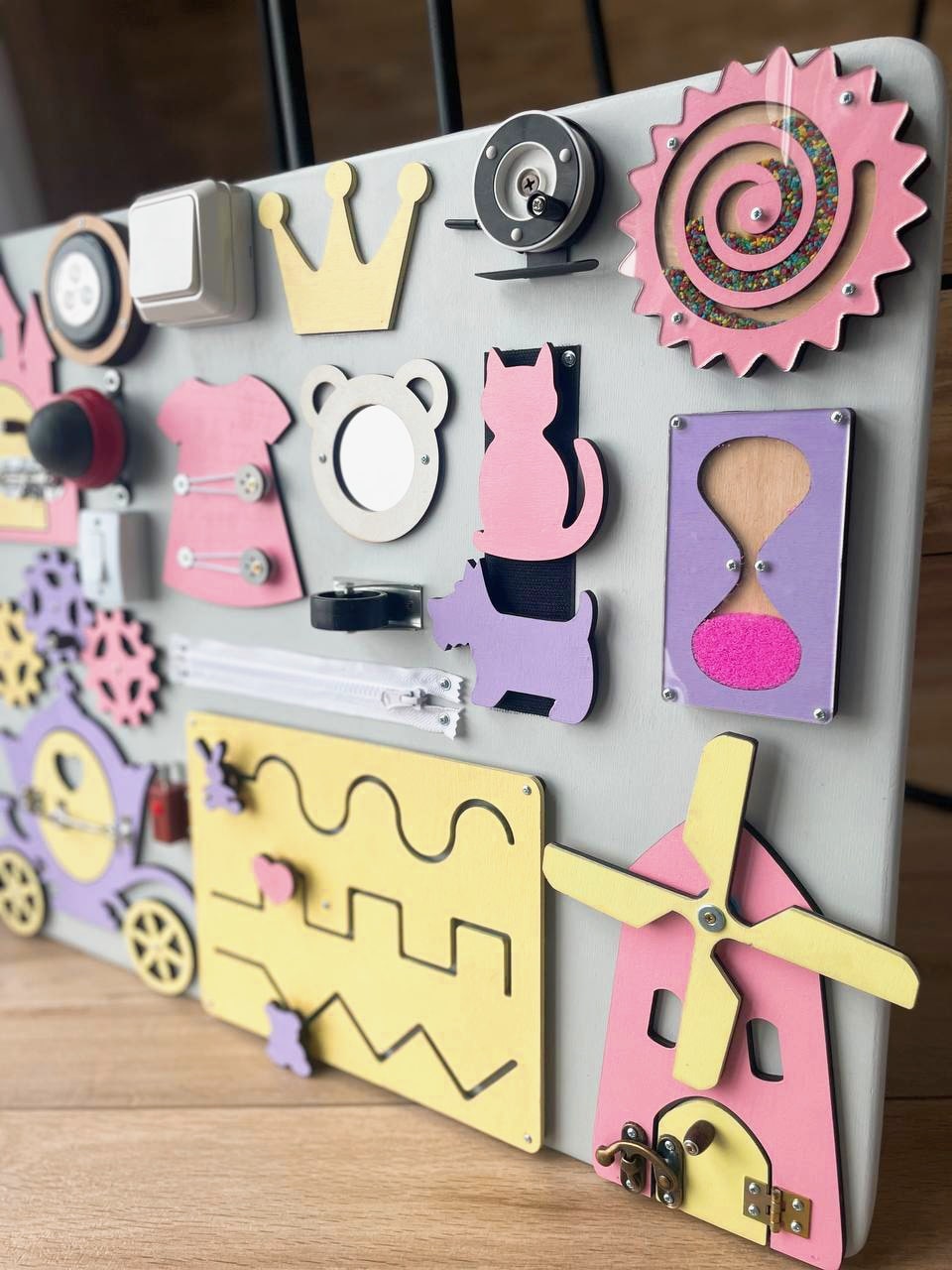 Purple Busy Board MAXI featuring various engaging activities for toddlers, designed to enhance motor skills and sensory development.