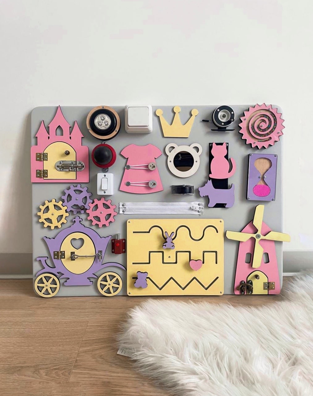 Purple Busy Board MAXI featuring various engaging activities for toddlers, designed to enhance motor skills and sensory development.