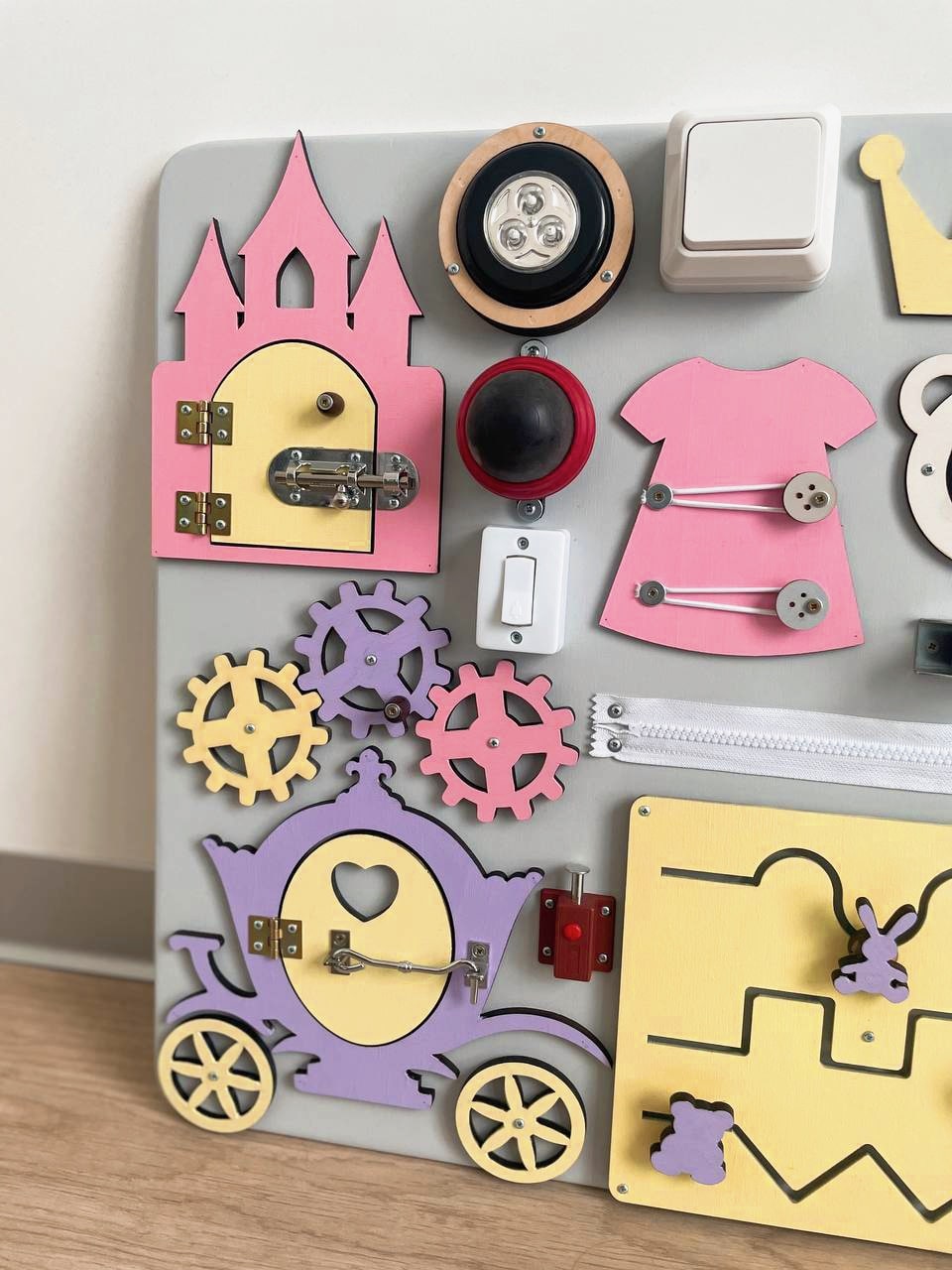 Purple Busy Board MAXI featuring various engaging activities for toddlers, designed to enhance motor skills and sensory development.