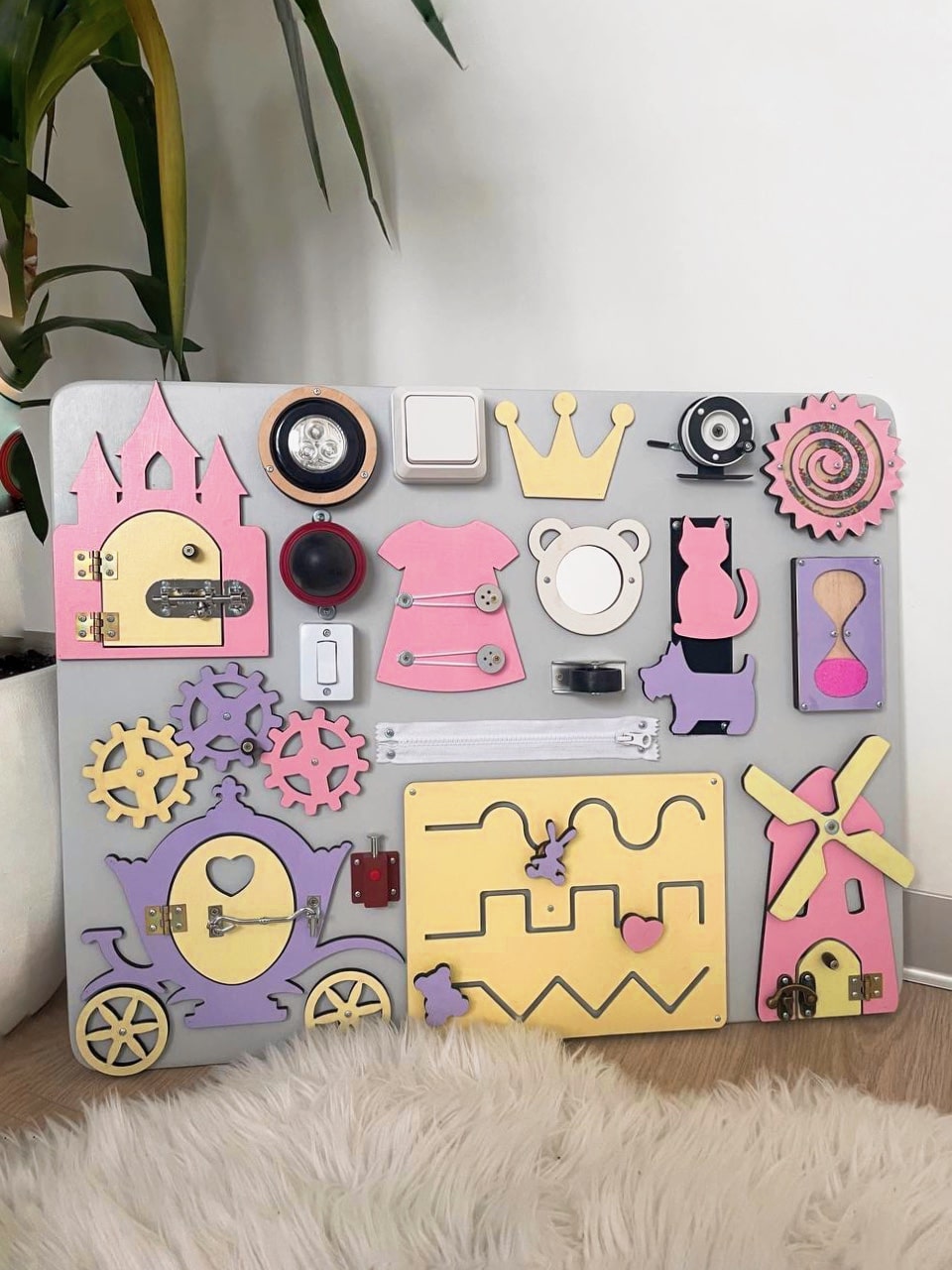 Purple Busy Board MAXI featuring various engaging activities for toddlers, designed to enhance motor skills and sensory development.