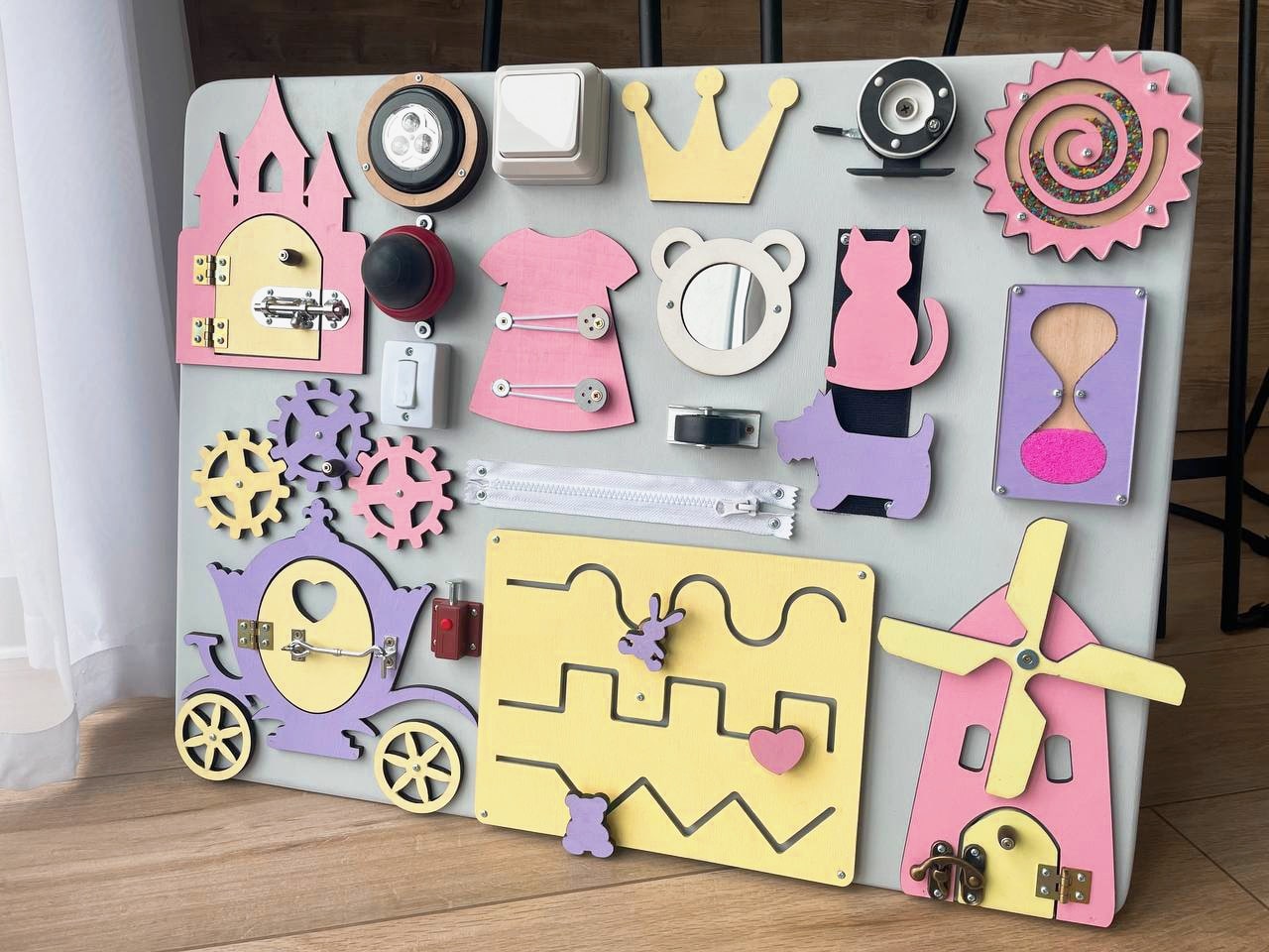 Purple Busy Board MAXI featuring various engaging activities for toddlers, designed to enhance motor skills and sensory development.