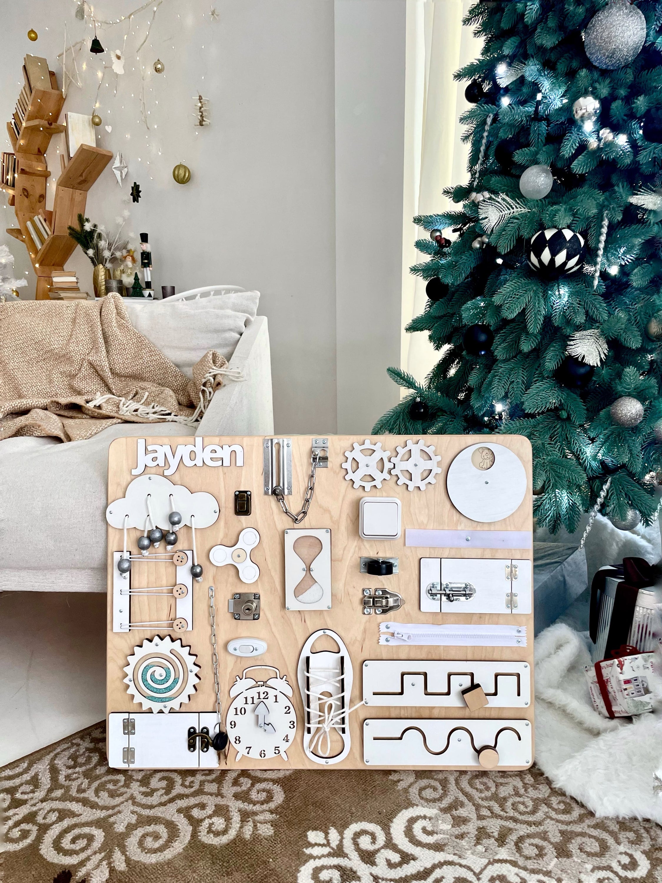 Busy Board MAXI in white wood, featuring various interactive elements for children's play and learning.