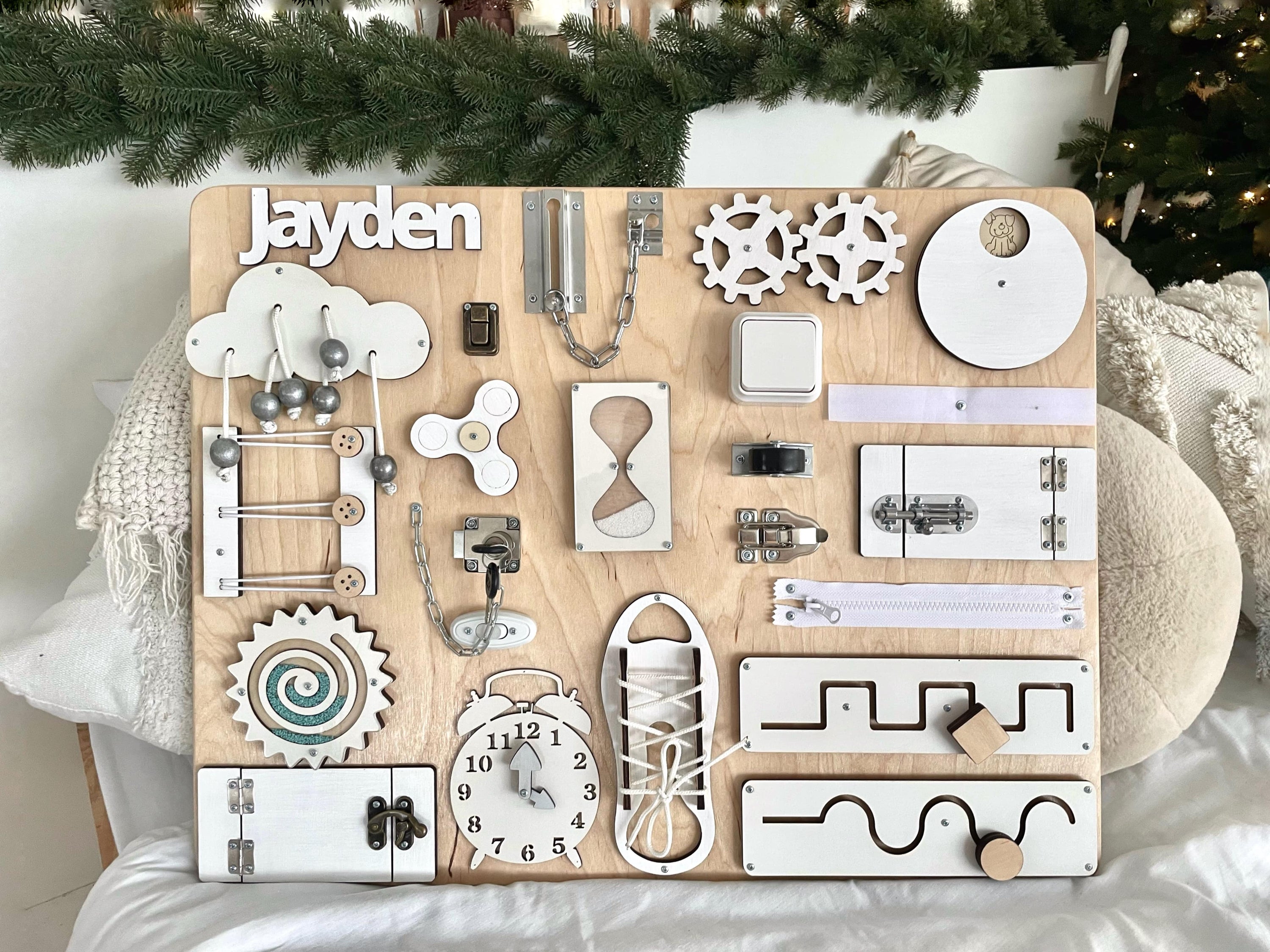 Busy Board MAXI in white wood, featuring various interactive elements for children's play and learning.