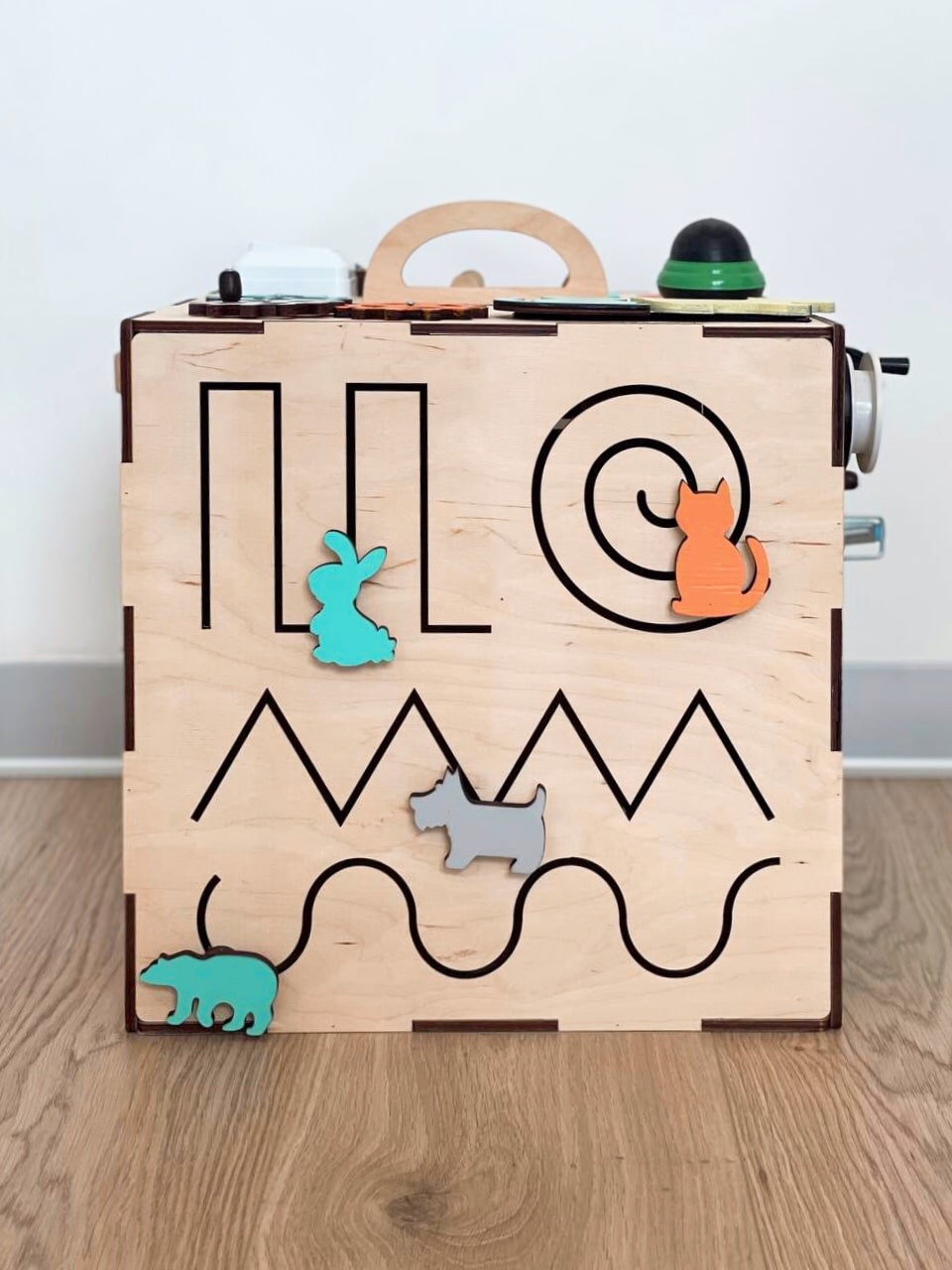 A colorful Busy Cube 13 inches featuring five busy boards with various engaging game elements for children's skill development.