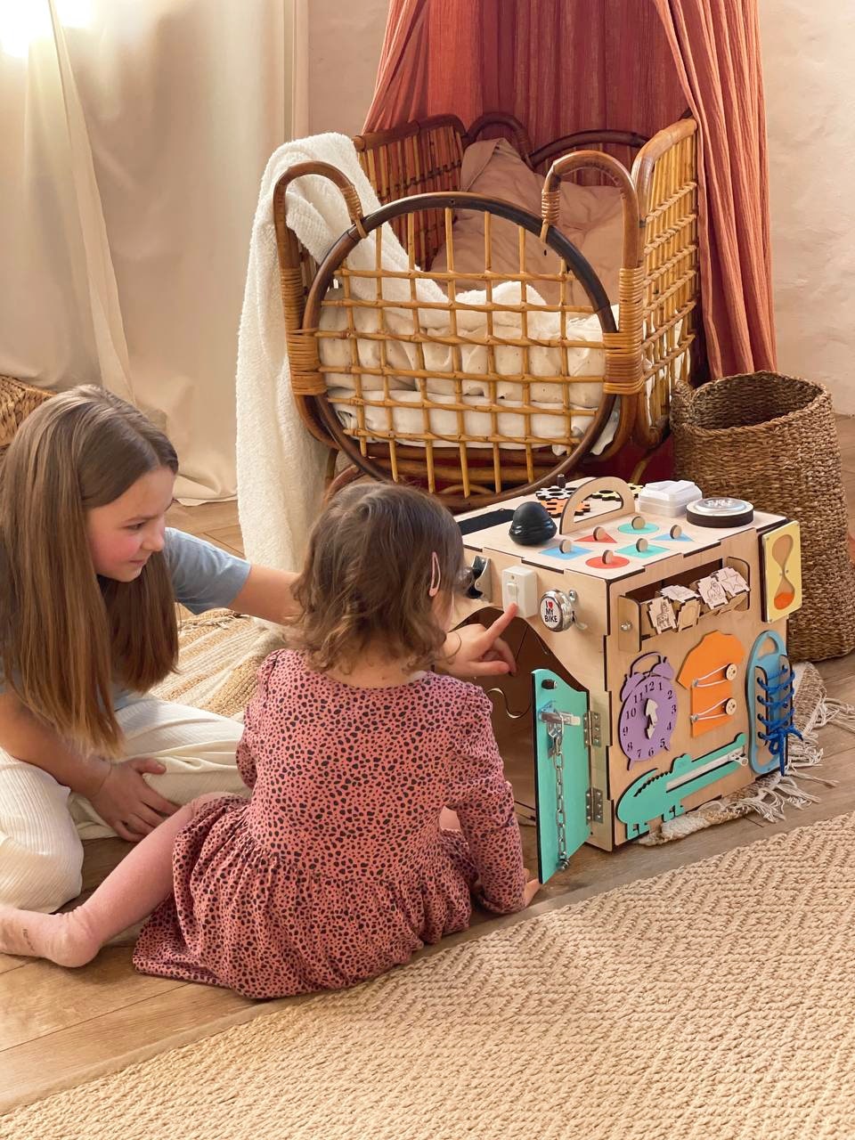 A colorful Busy Cube 13 inches featuring five busy boards with various engaging game elements for children's skill development.