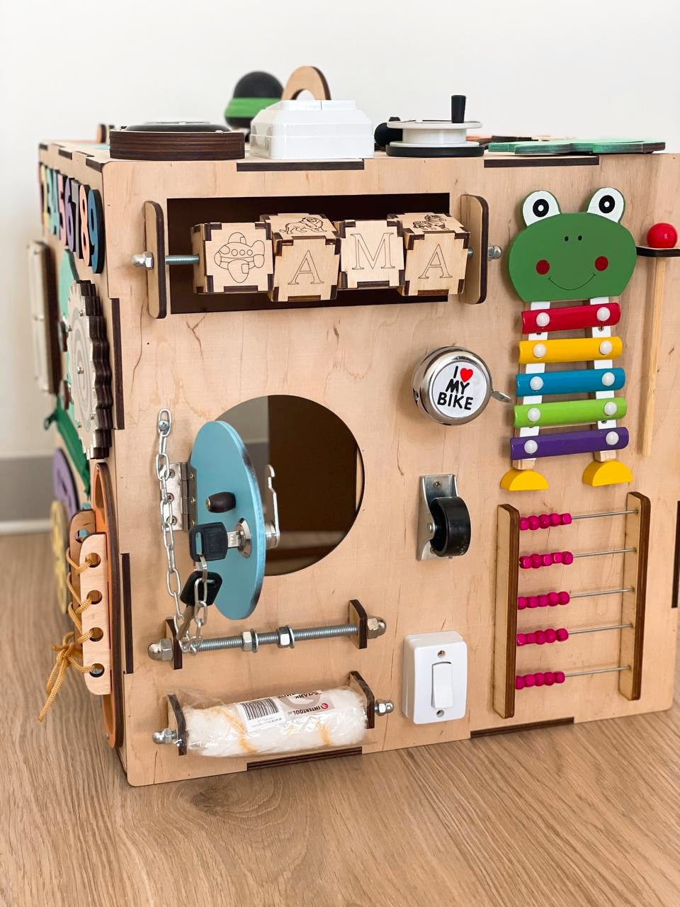 A colorful Busy Cube measuring 15 inches, featuring various engaging busy boards designed for children's skill development and creativity.