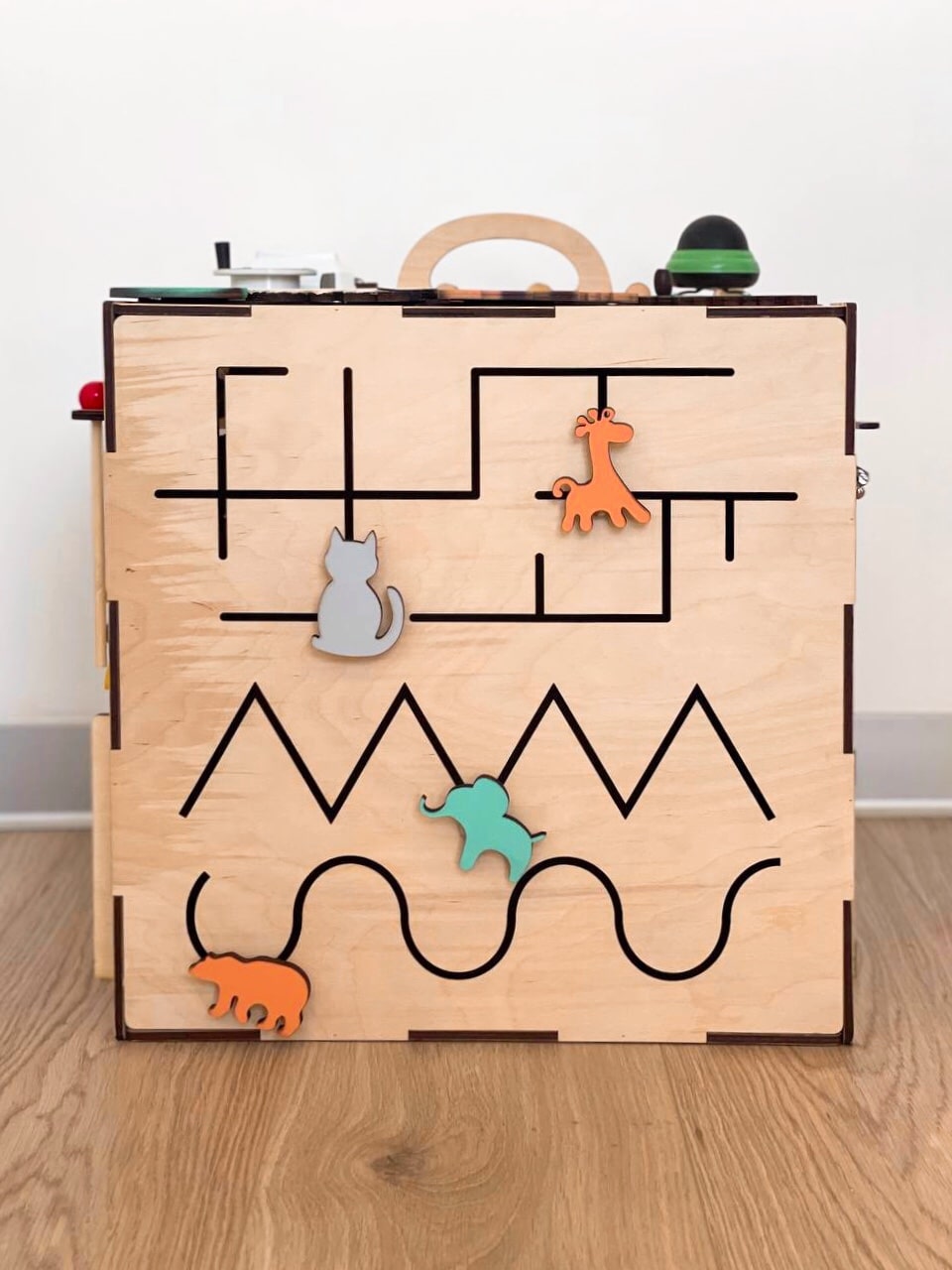 A colorful Busy Cube measuring 15 inches, featuring various engaging busy boards designed for children's skill development and creativity.