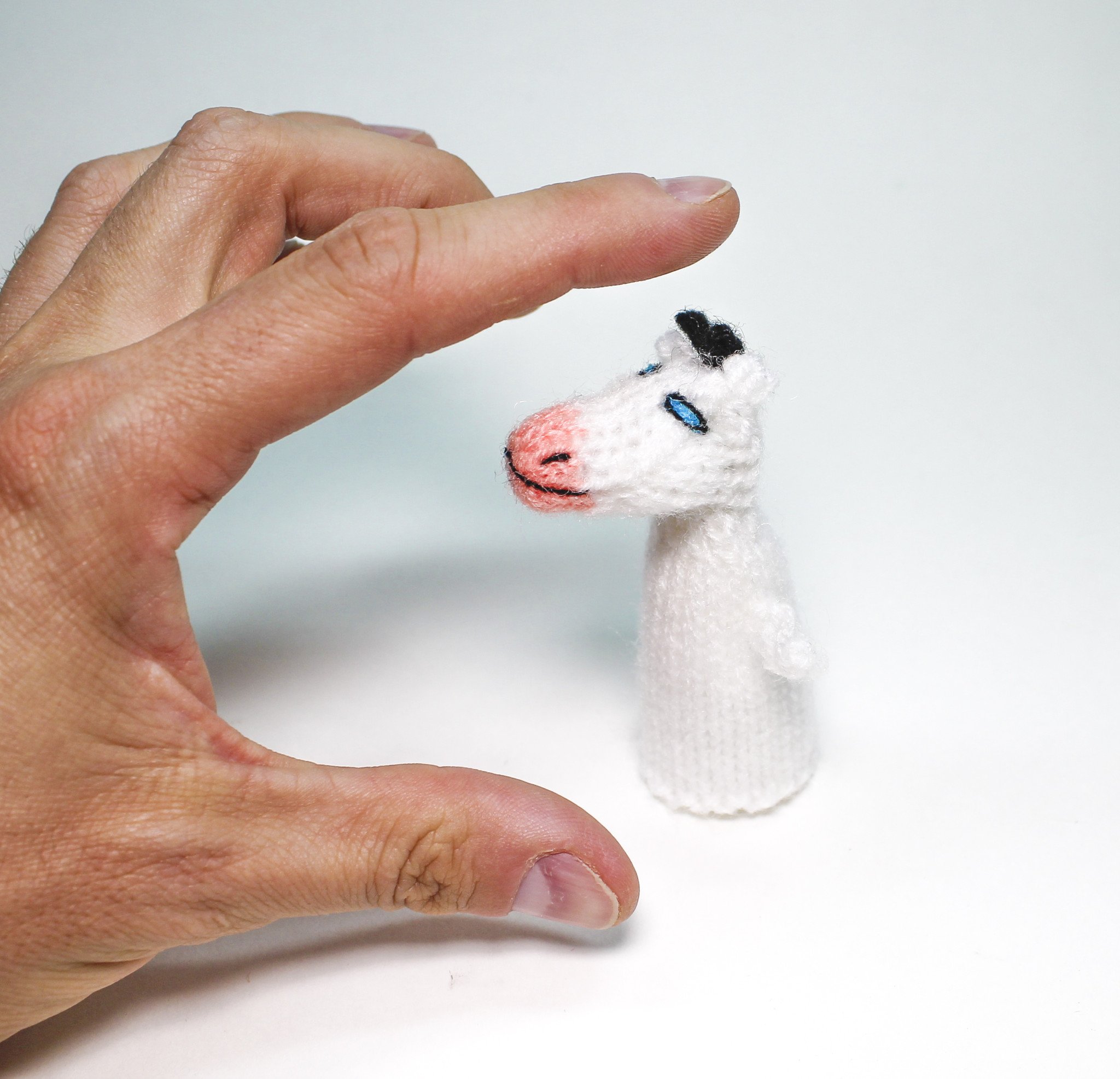 Colorful Calf Finger Puppet handcrafted by Peruvian artisans, showcasing unique design and vibrant colors.