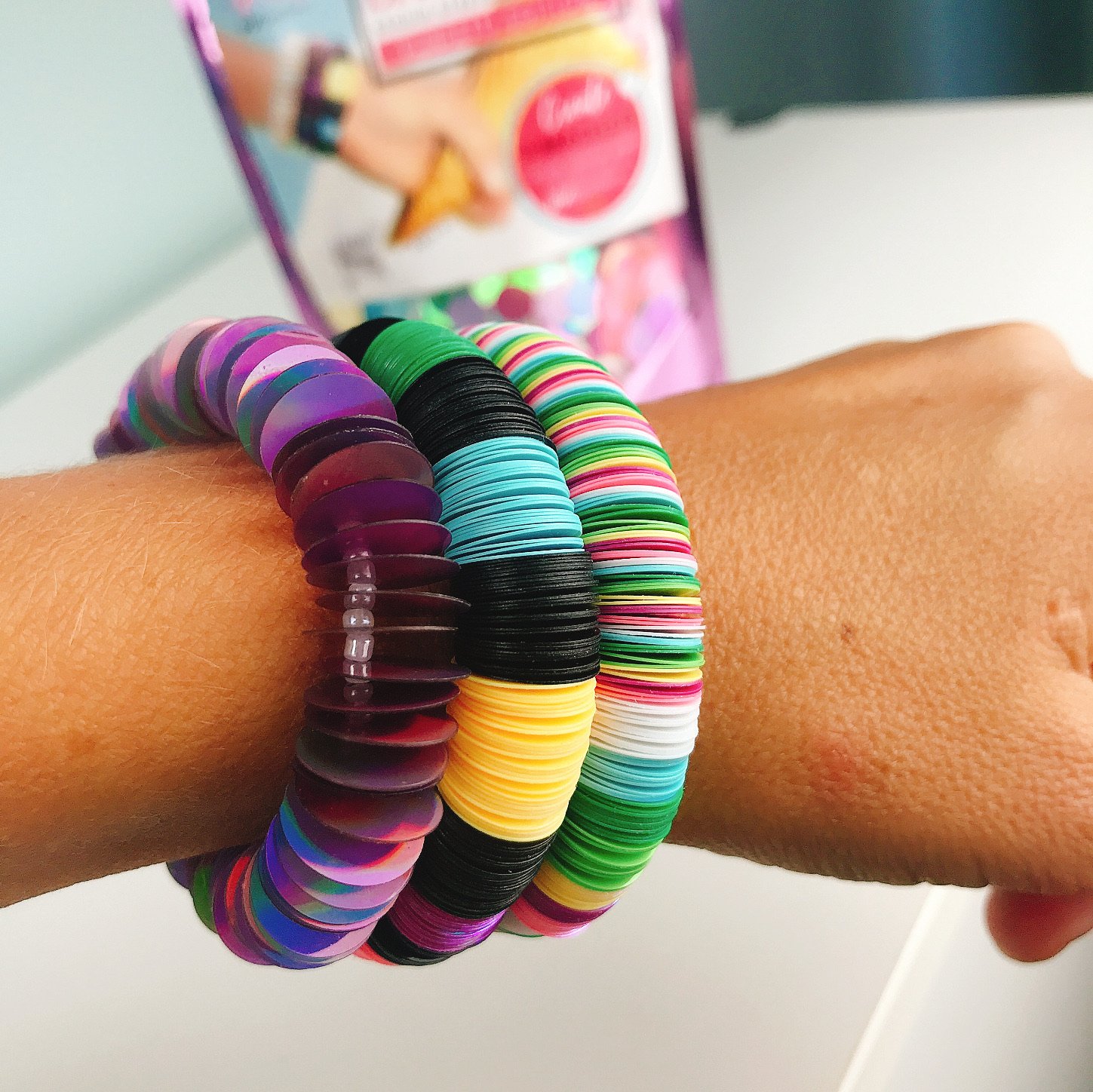DIY Bracelet Kit - Funfetti Edition featuring colorful holographic sequins, elastic cord, and spacer beads for crafting three unique bracelets.